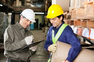 Foreman Looking At Supervisor Writing Notes